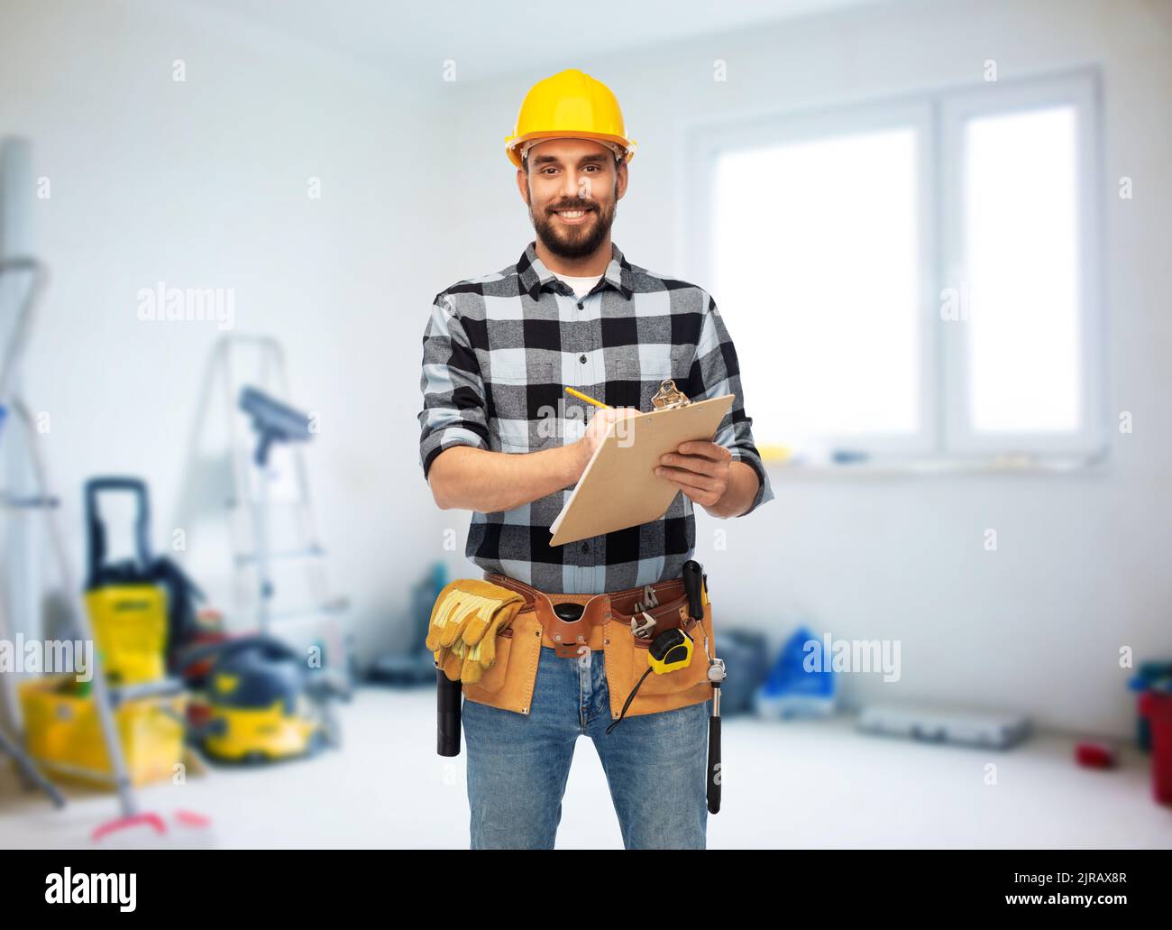 male worker or builder in helmet with clipboard Stock Photo