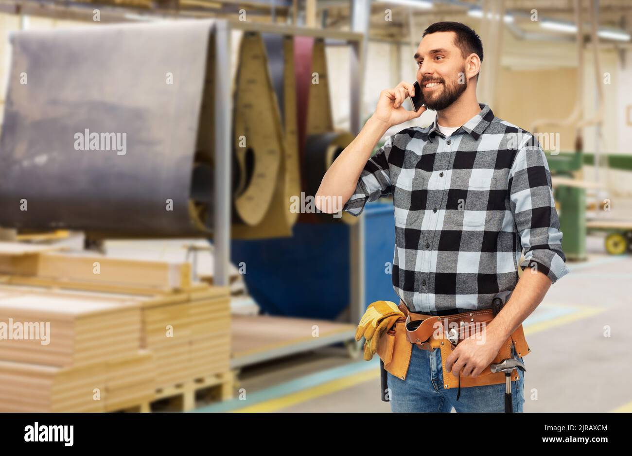 builder in helmet calling on smartphone Stock Photo