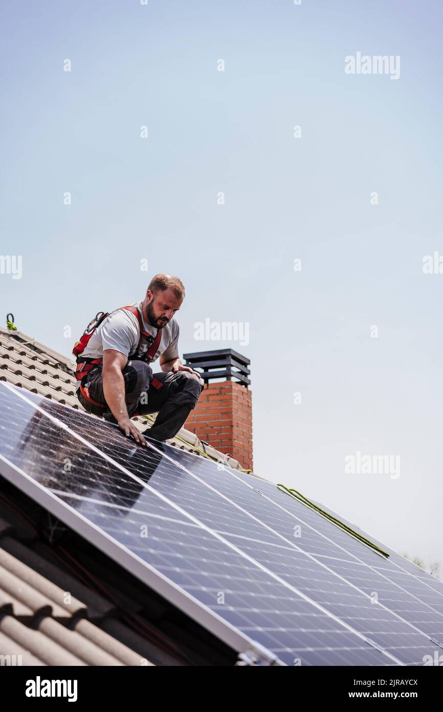 Electrician installing solar panels on roof Stock Photo Alamy