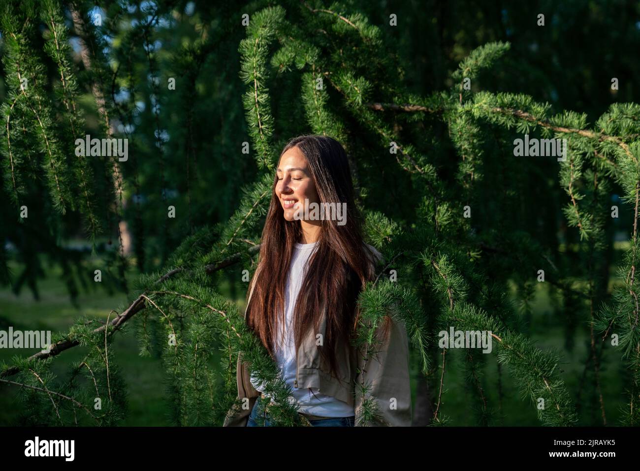 Happy woman with eyes closed in park Stock Photo - Alamy