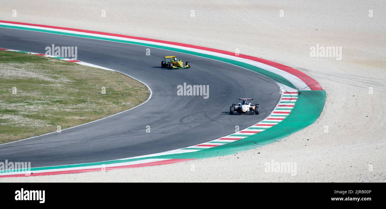 Asphalt racetrack turn and curbs with formula cars racing motor sport. Mugello, Italy, march 25 2022. 24 Hours series Stock Photo