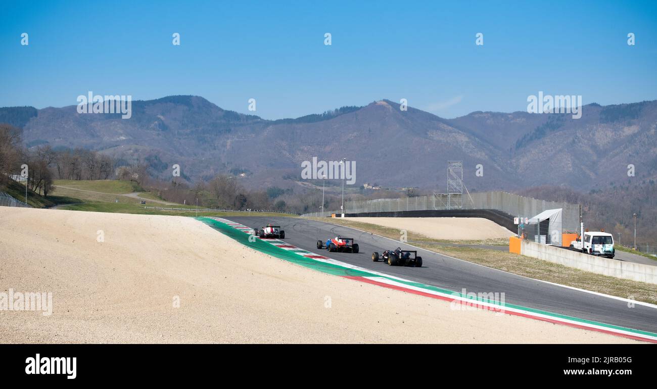 Racetrack landscape view with mountains panoramic background and cars racing on track. Mugello, Italy, march 25 2022. 24 Hours series Stock Photo
