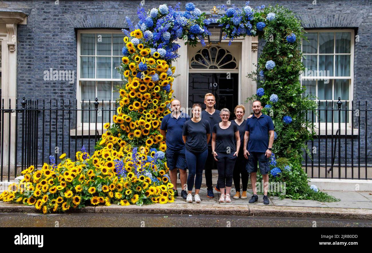 London, UK. 23rd Aug, 2022. The team of florists pose for a photo having completed their display. The finishing touches are put on the floral display at Number 10 Downing Street to mark independence day for Ukraine which is tomorrow, August 24th. Credit: Mark Thomas/Alamy Live News Stock Photo