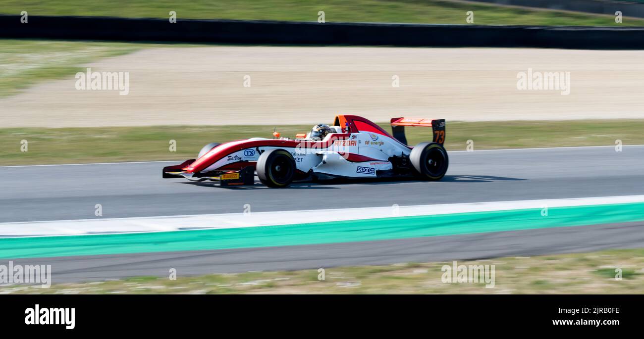 Formula race car action on racetrack blurred motion background. Mugello, Italy, march 25 2022. 24 Hours series Stock Photo