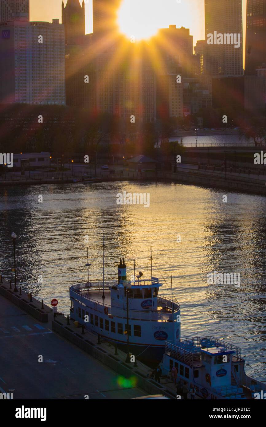 A vertical shot of docked boats and Chicago skyline at sunset Stock ...