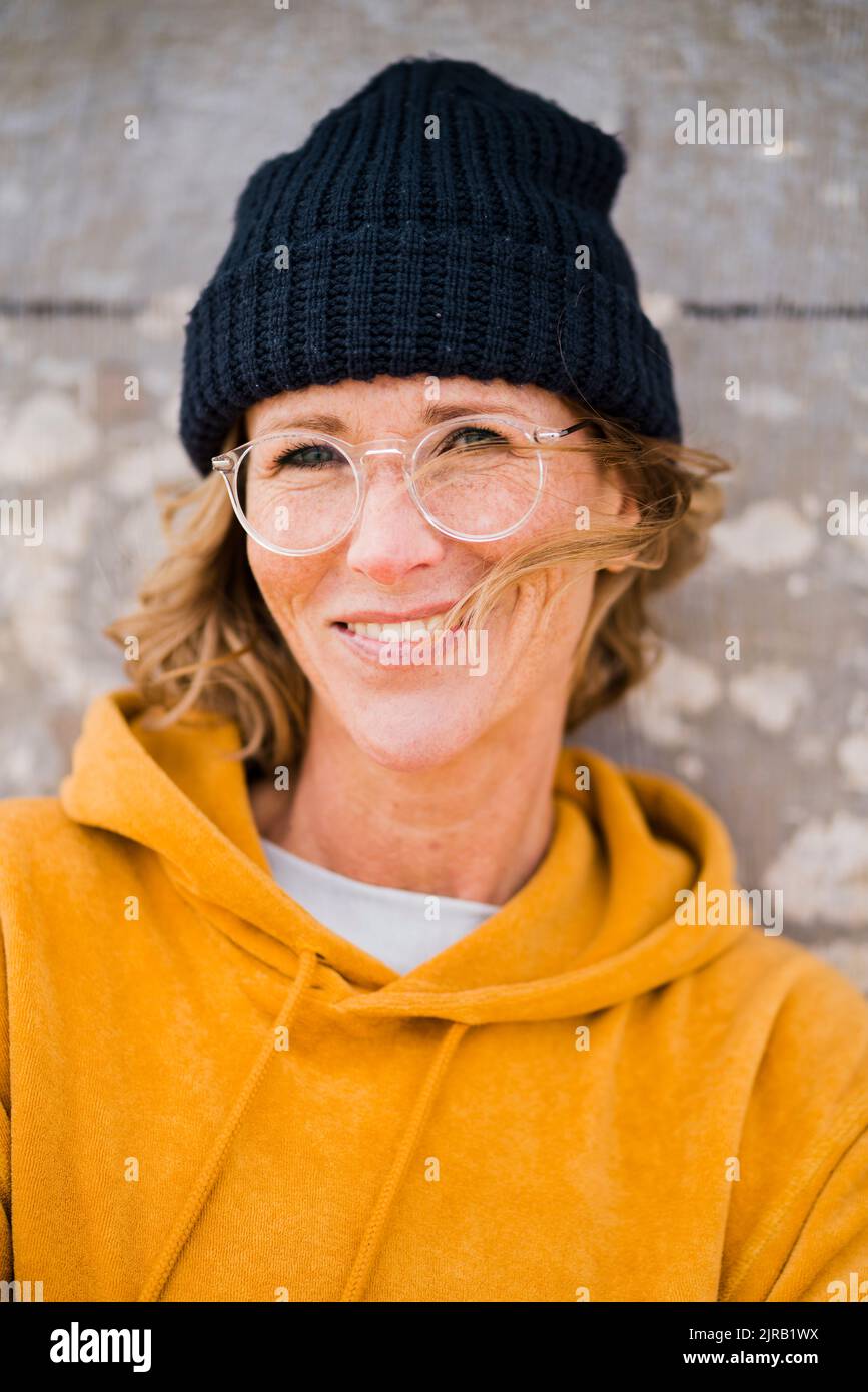Happy mature woman wearing knit hat Stock Photo