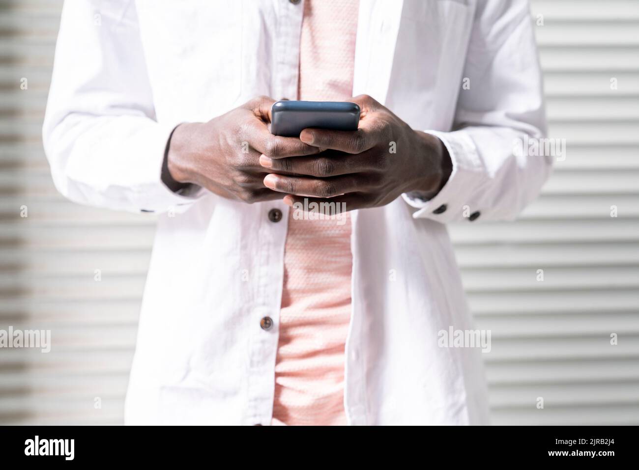 Young man text messaging through smart phone Stock Photo
