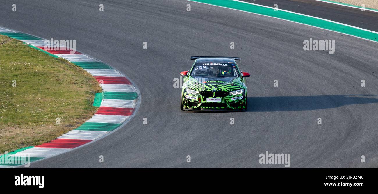 BMW M4 gt race car action on racetrack turn. Mugello, Italy, march 25 2022. 24 Hours series Stock Photo