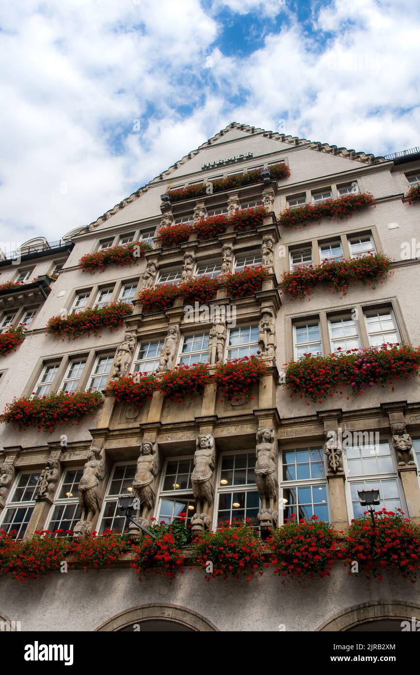 Historic medieval style buildings with flower pots at Marienplatz