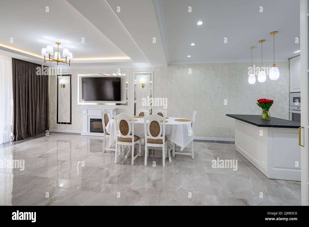 Luxury white spacious domestic kitchen with marble floor Stock Photo