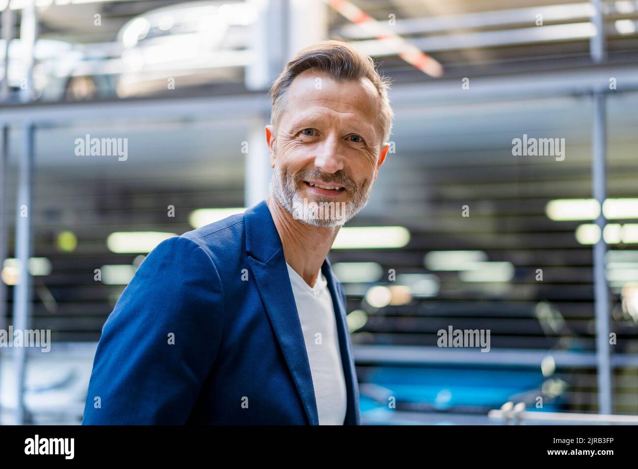 Smiling mature businessman wearing blazer Stock Photo