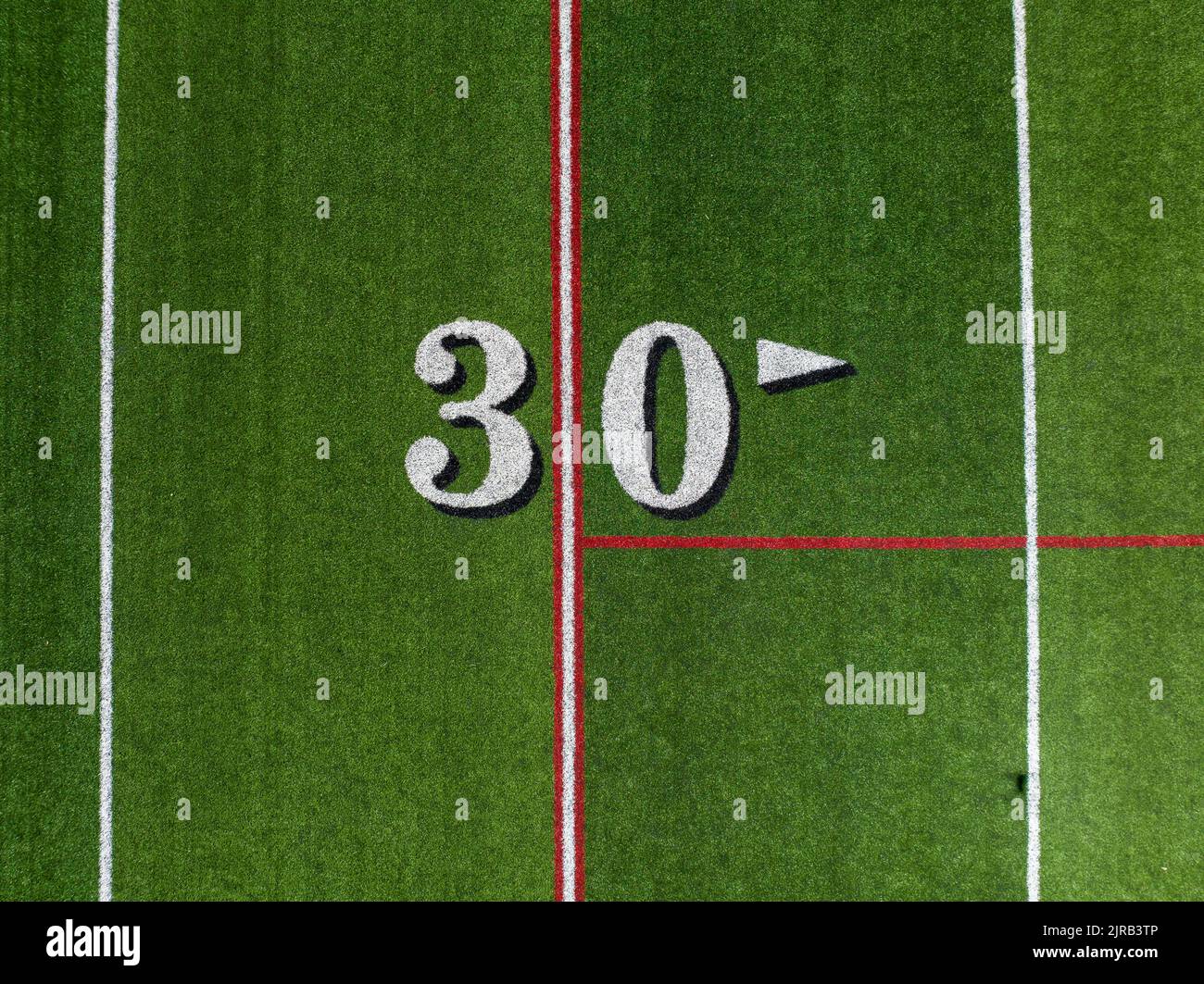 Synthetic turf slanted football 30 yard line in white with black number