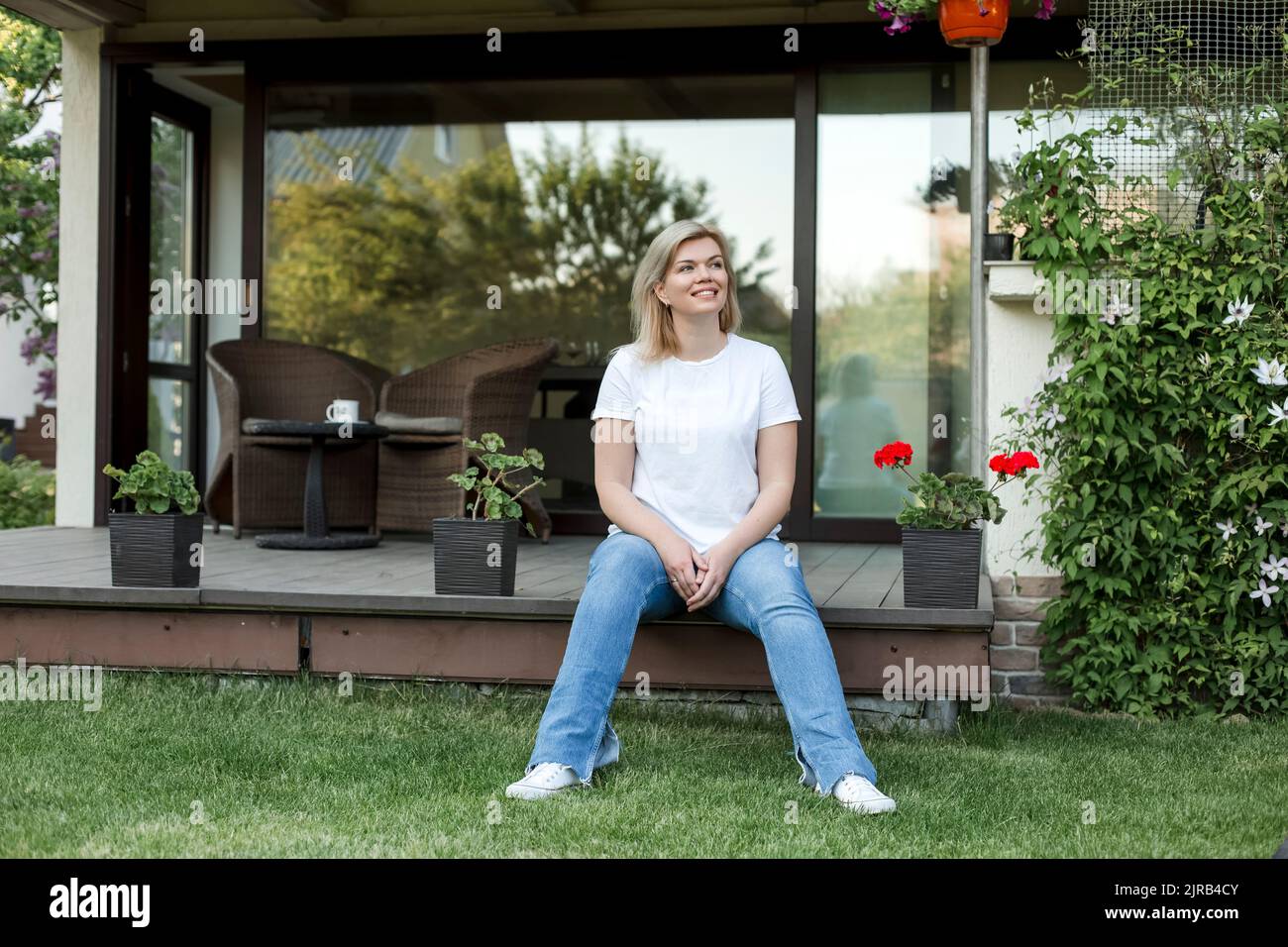 Smiling mature woman sitting on porch Stock Photo - Alamy