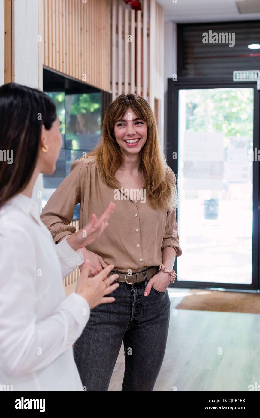 Two happy businesswomen talking in office Stock Photo