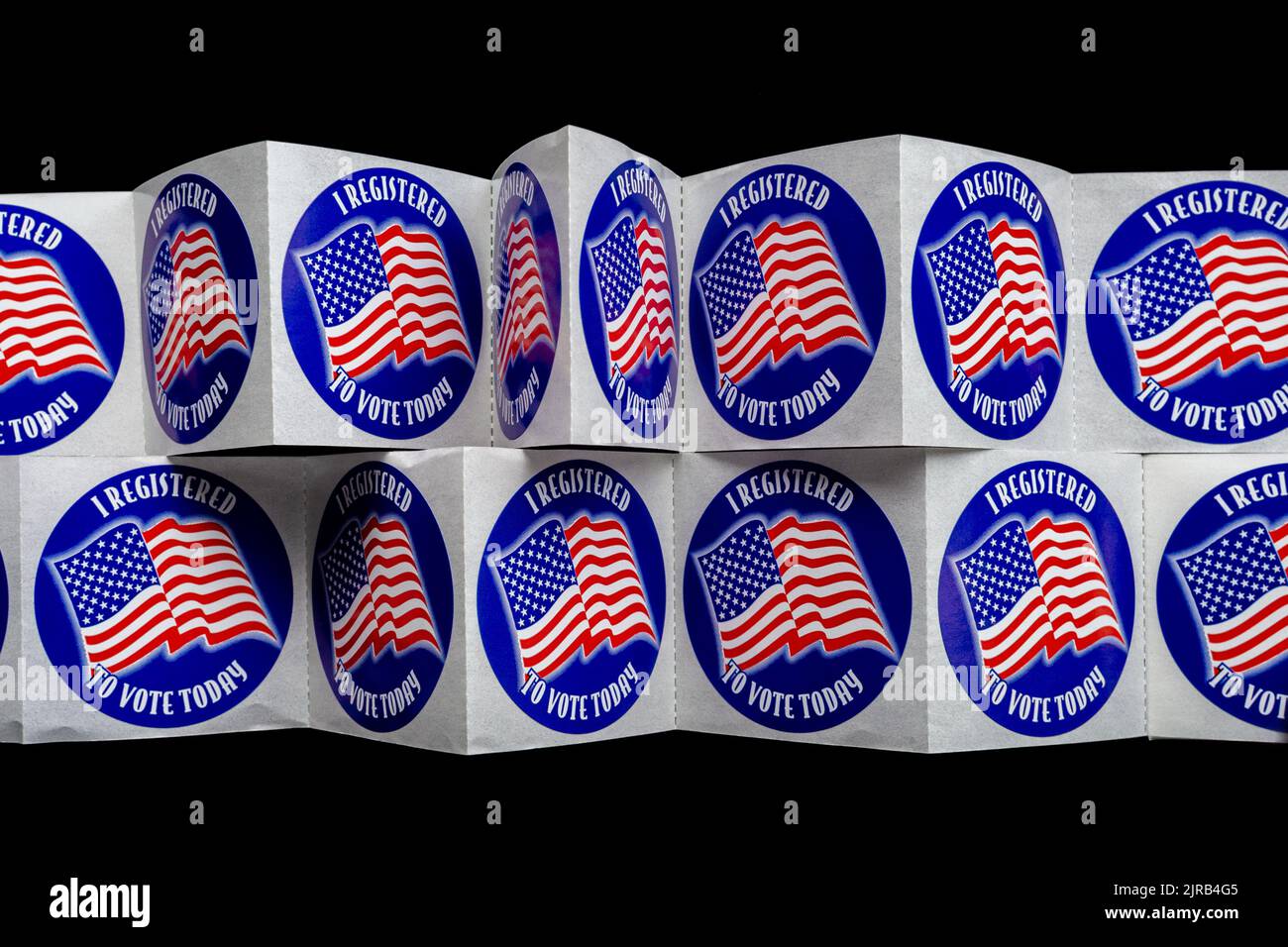 Two rows of stickers with the American flag proclaim, 'I registered to vote today.' Stock Photo