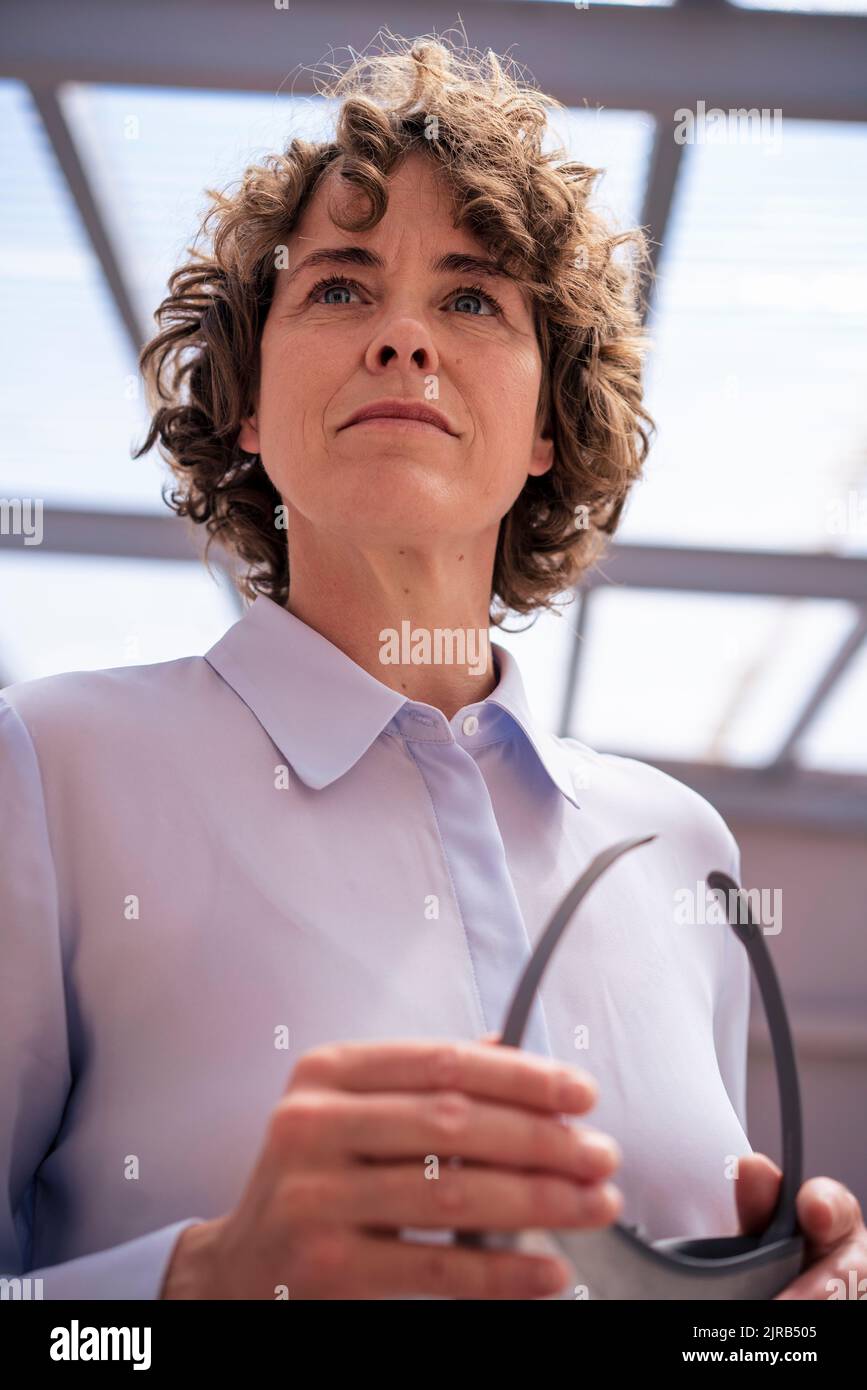 Real estate agent with curly hair at home Stock Photo Alamy