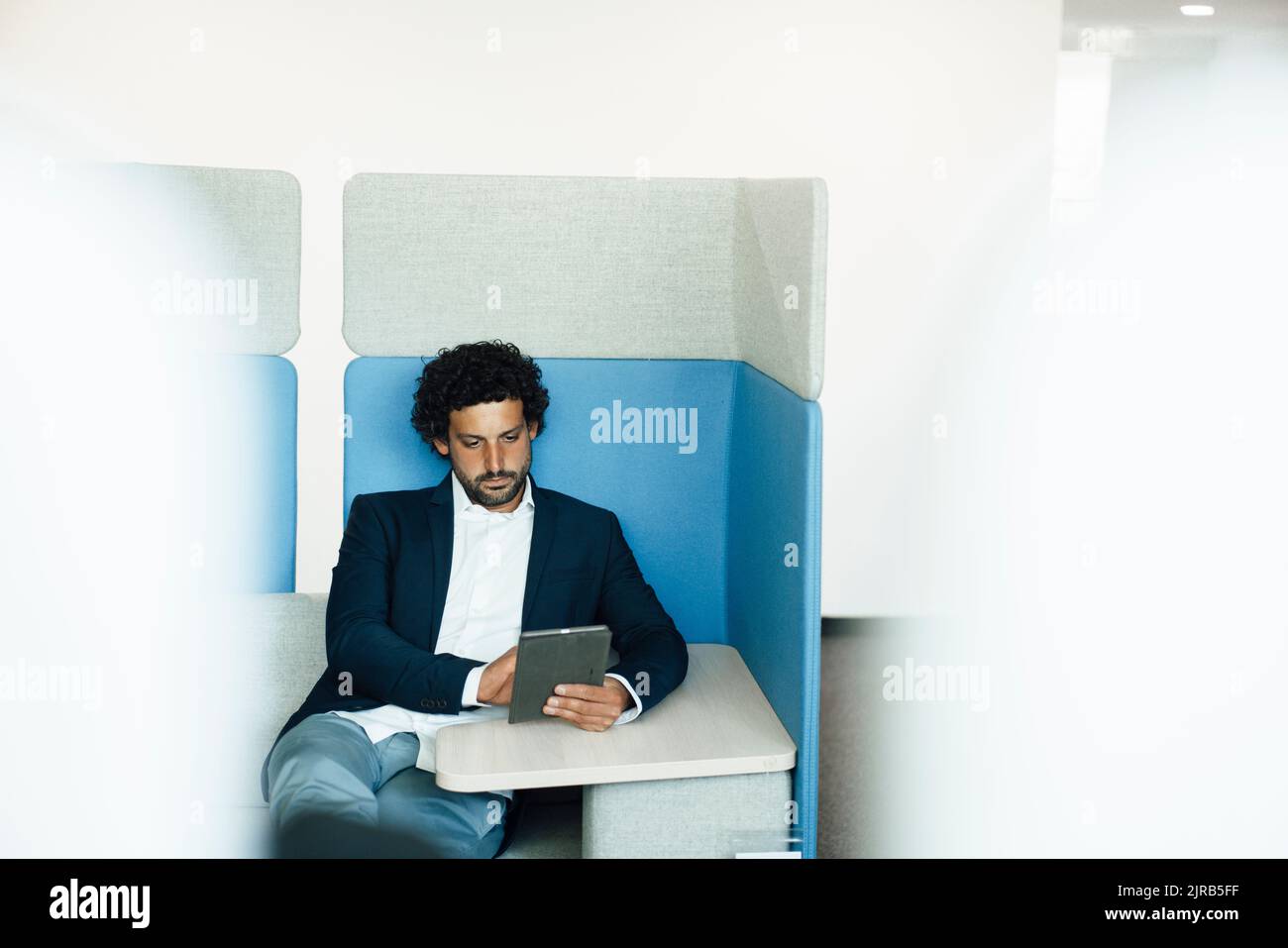 Businessman using tablet computer at workplace Stock Photo