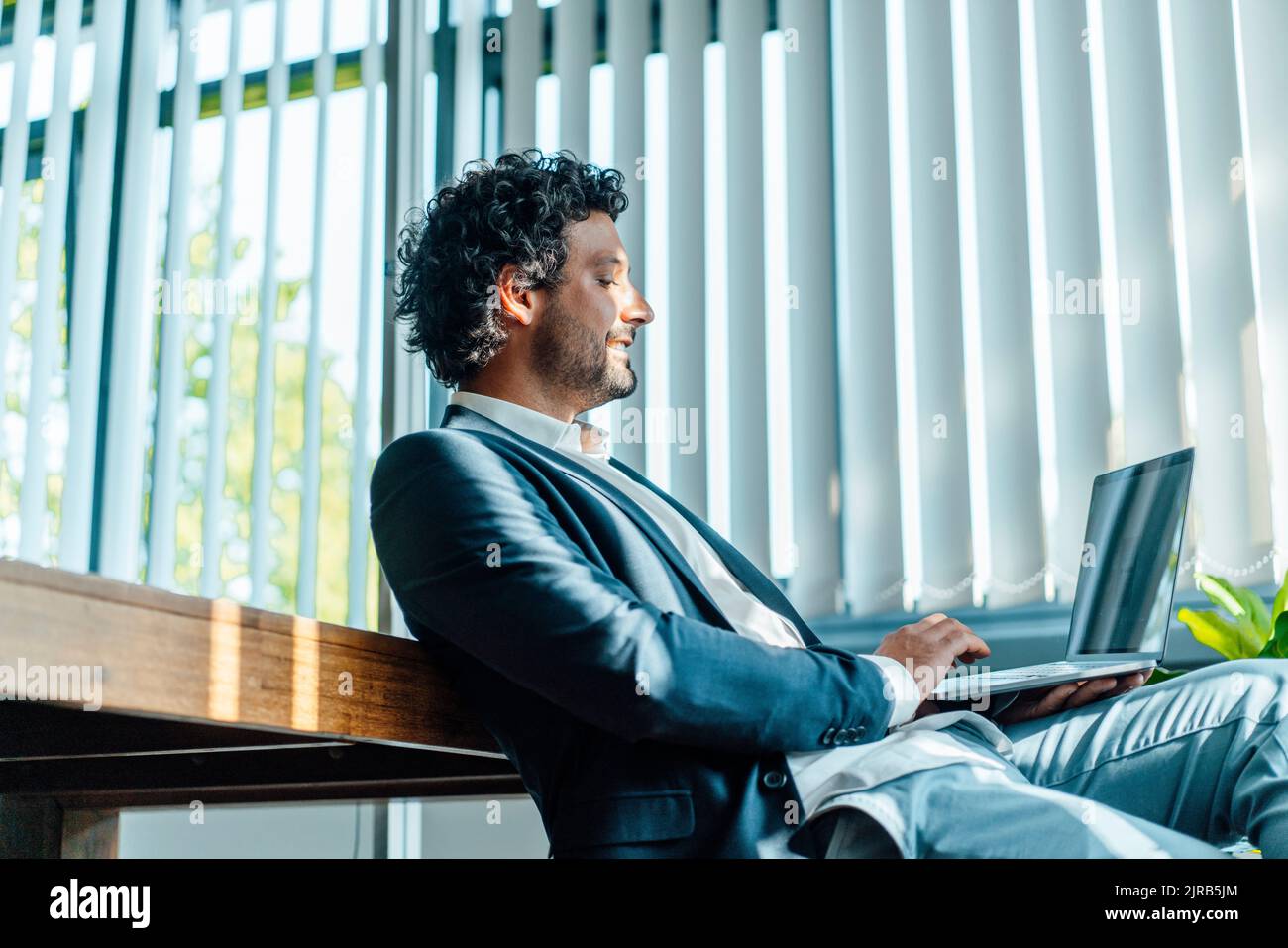Businessman using laptop working in office Stock Photo
