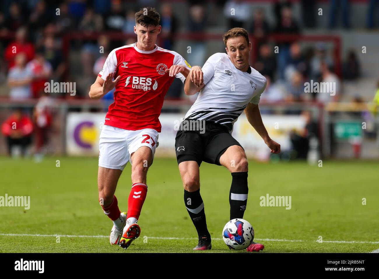 Fleetwood Town’s Harvey Macadam and Derby County’s Craig Forsyth battle for the ball during the Sky Bet League One match at Highbury Stadium, Fleetwood. Picture date: Saturday August 20, 2022. Stock Photo