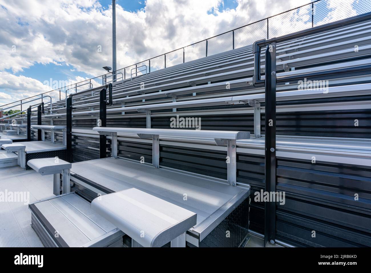 Empty metal outdoor stadium accessible bleacher seats with companion