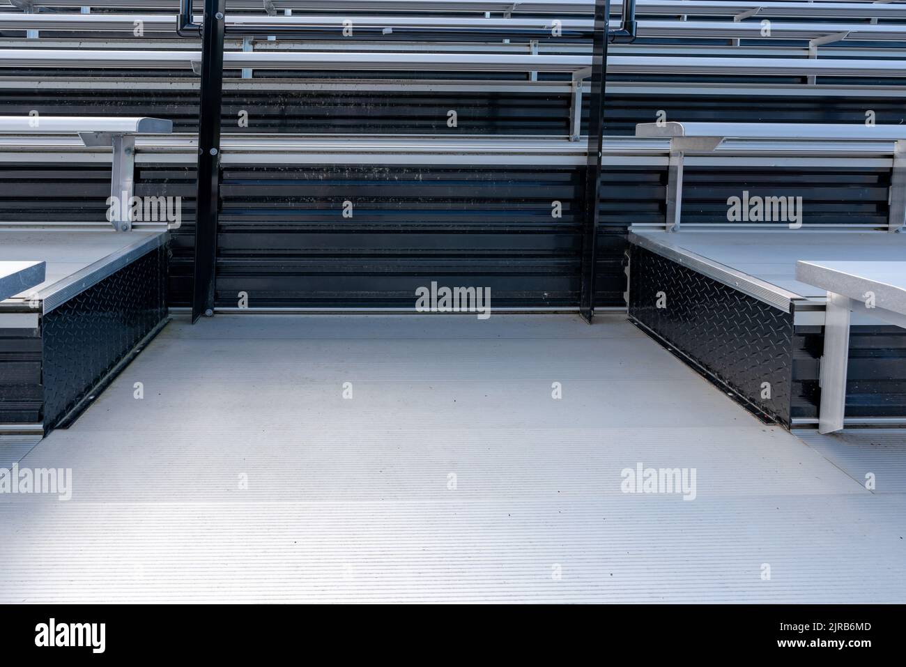 Empty metal outdoor stadium accessible bleacher seats with companion