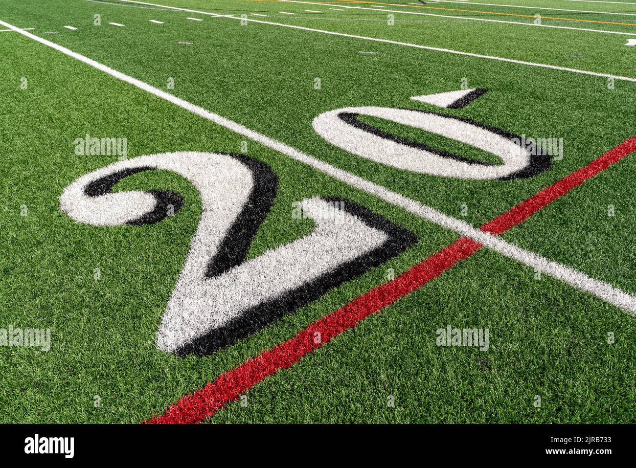 Synthetic turf football field twenty, 20, yard line in white Stock