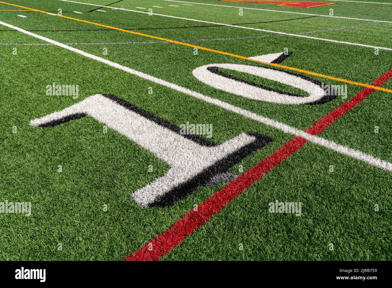 Synthetic turf slanted football 10 yard line in white with black number