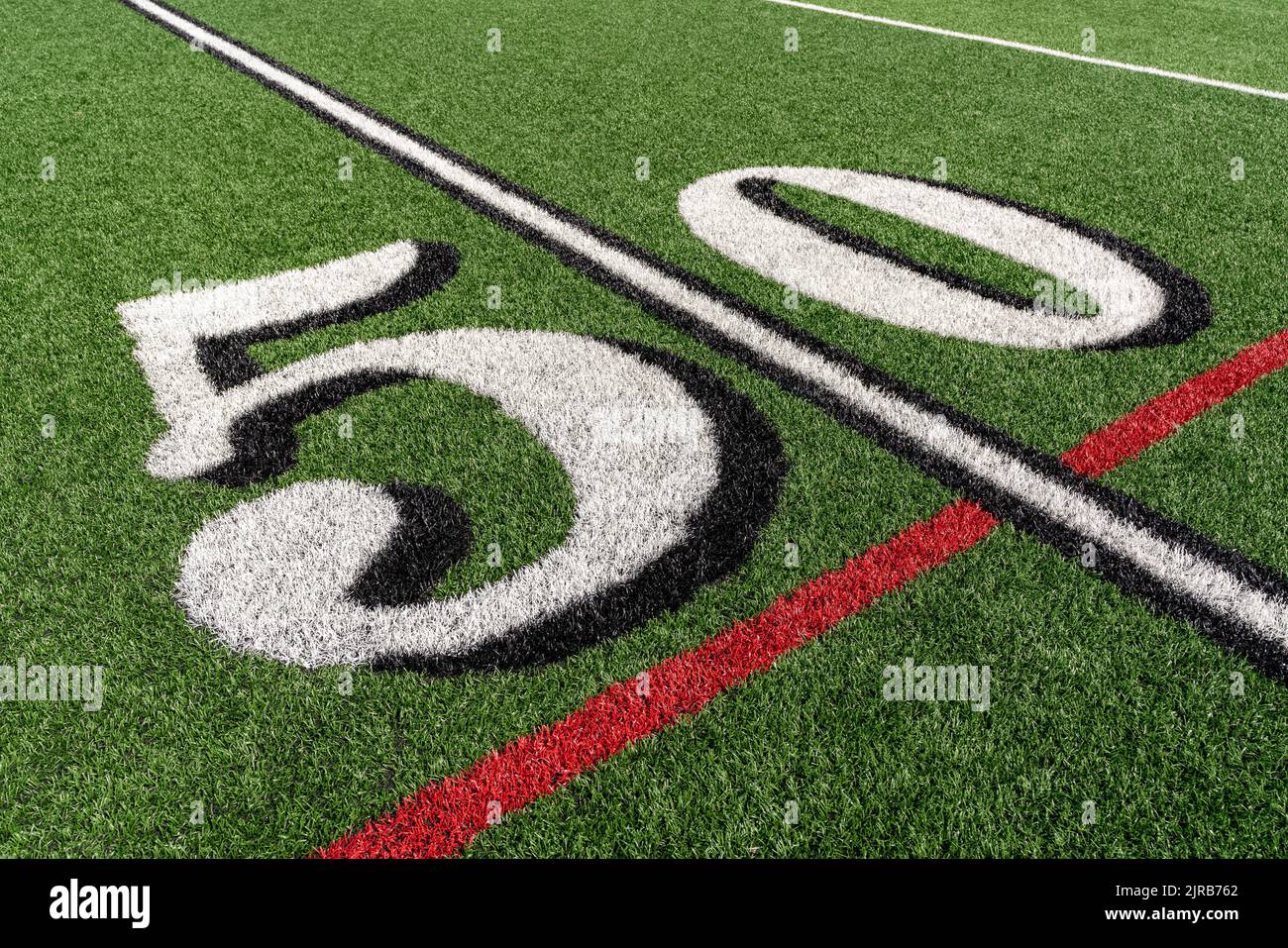 Synthetic turf slanted football 50 yard line in white with black number