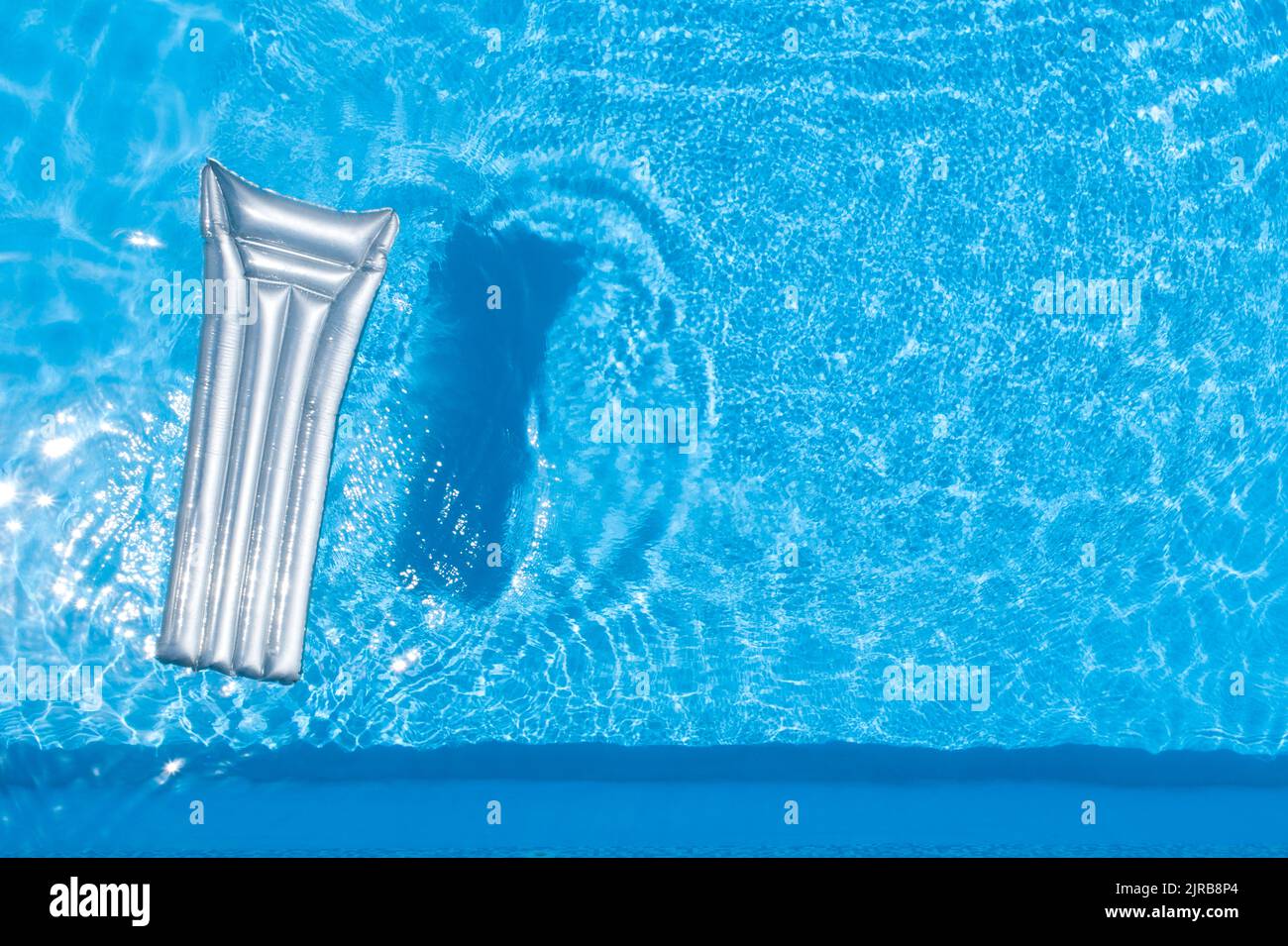 Pool raft floating on water in swimming pool Stock Photo Alamy