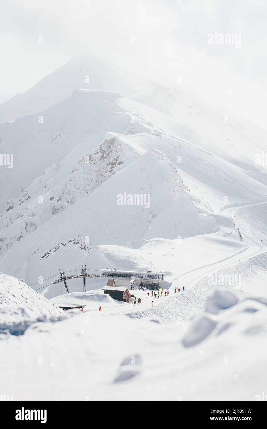 View of cable car station in front of snowy mountains Stock Photo