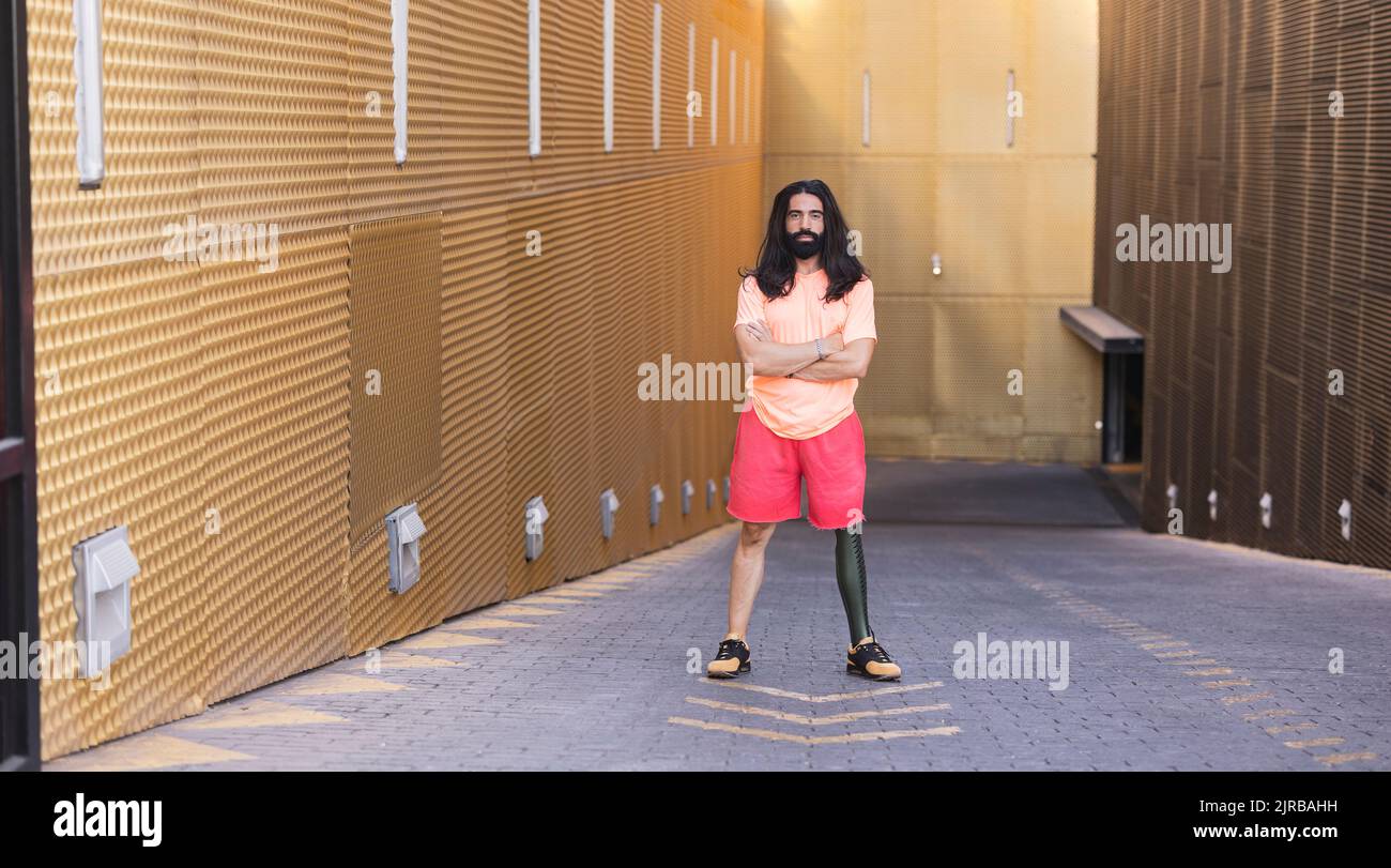 Bearded man with prosthetic leg standing on road Stock Photo