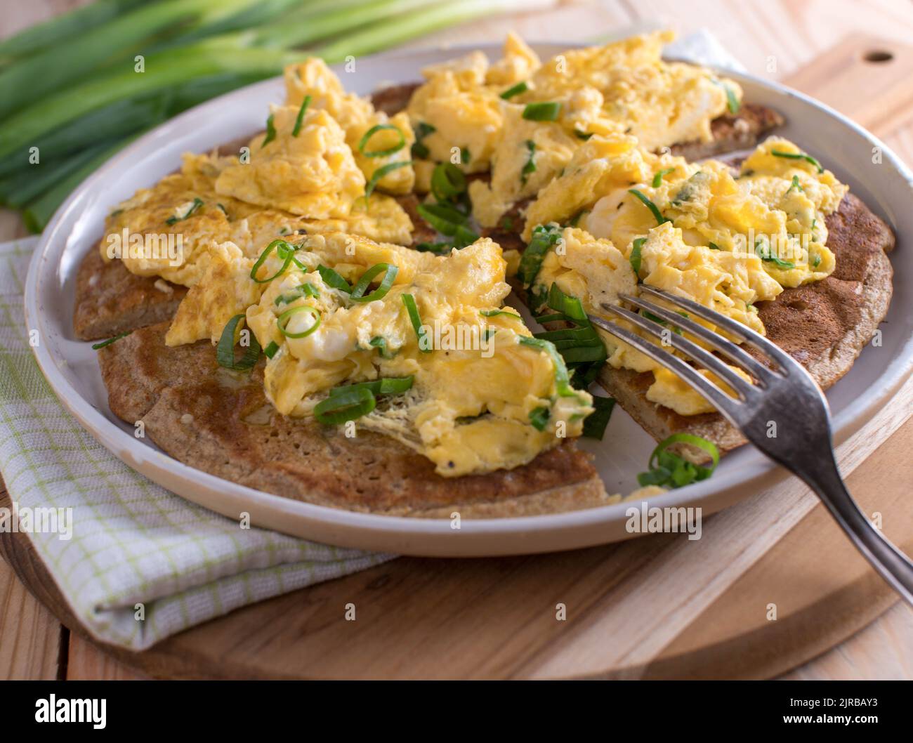 Oatmeal pancake with scrambled eggs and chives Stock Photo Alamy