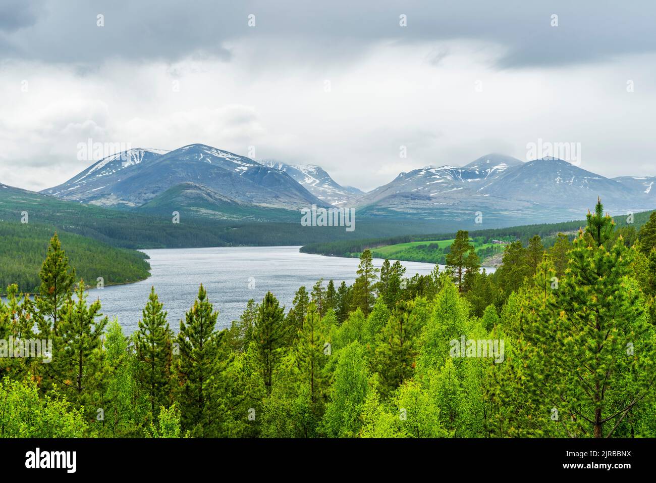 Norway, Innlandet, Lake in Rondane National Park with mountains in background Stock Photo