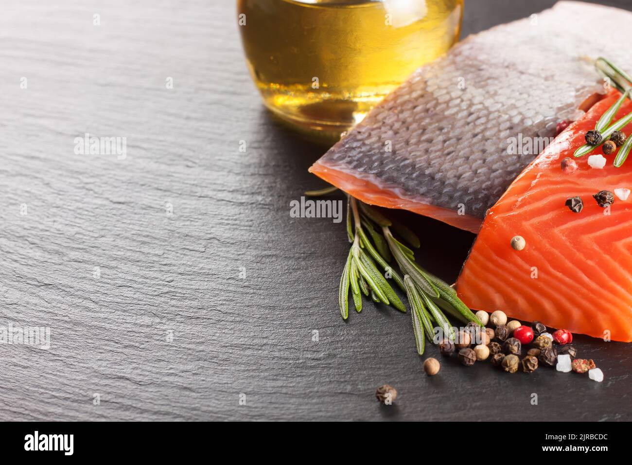 Raw salmon fillet and spices on a dark slate background Stock Photo - Alamy