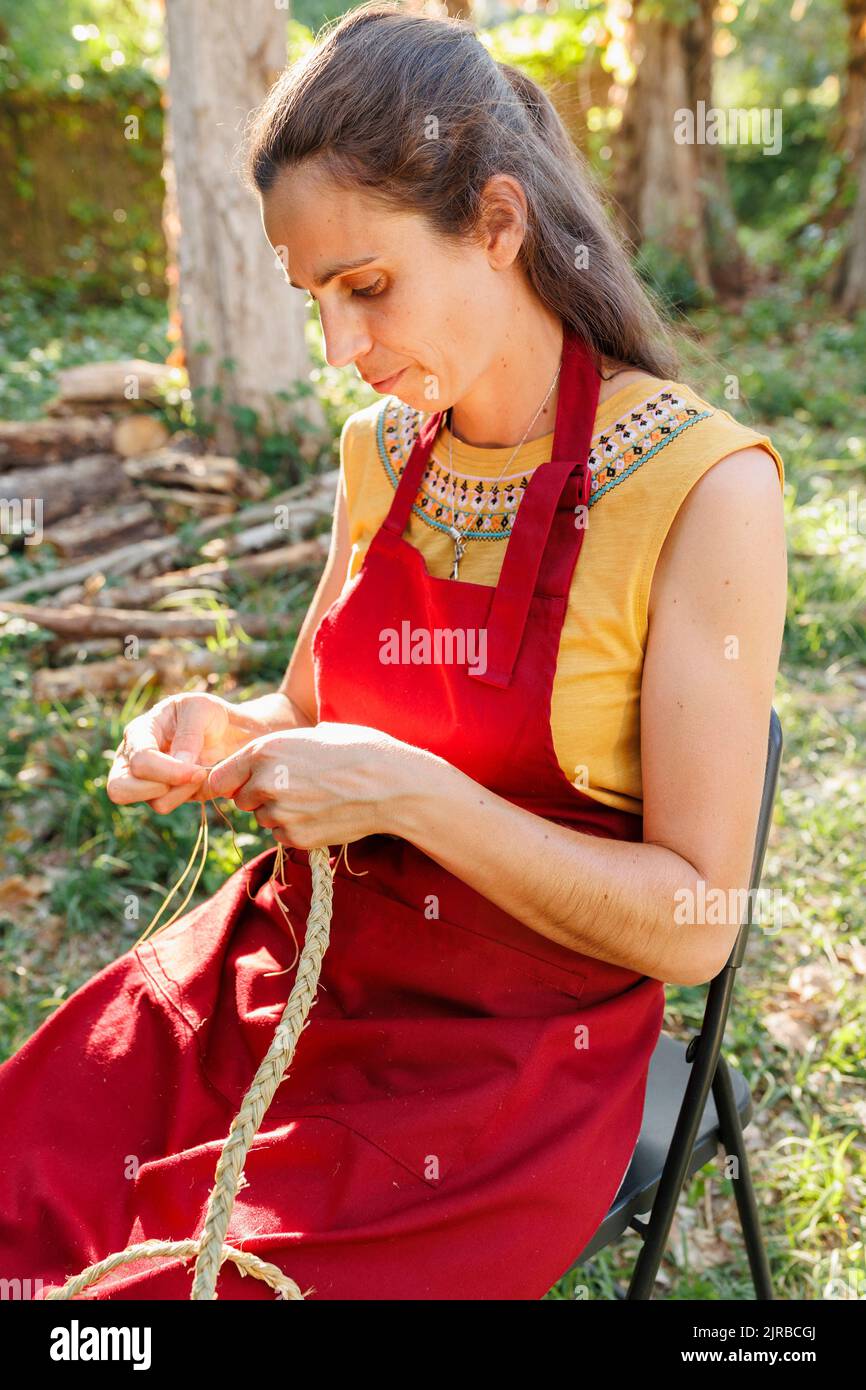 Artisan weaving esparto grass in garden Stock Photo Alamy