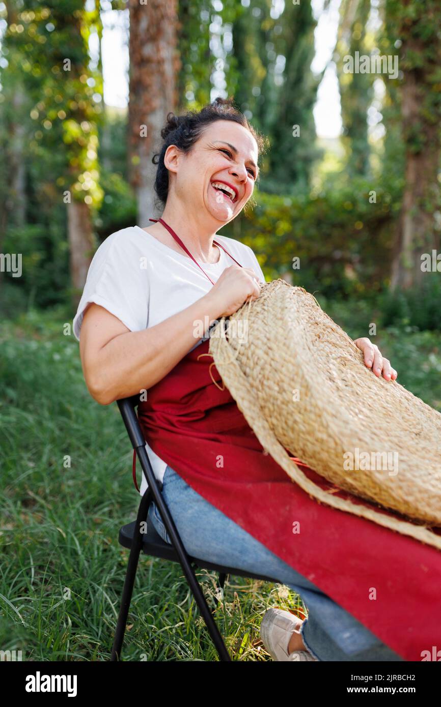 Happy artisan weaving with esparto grass Stock Photo Alamy