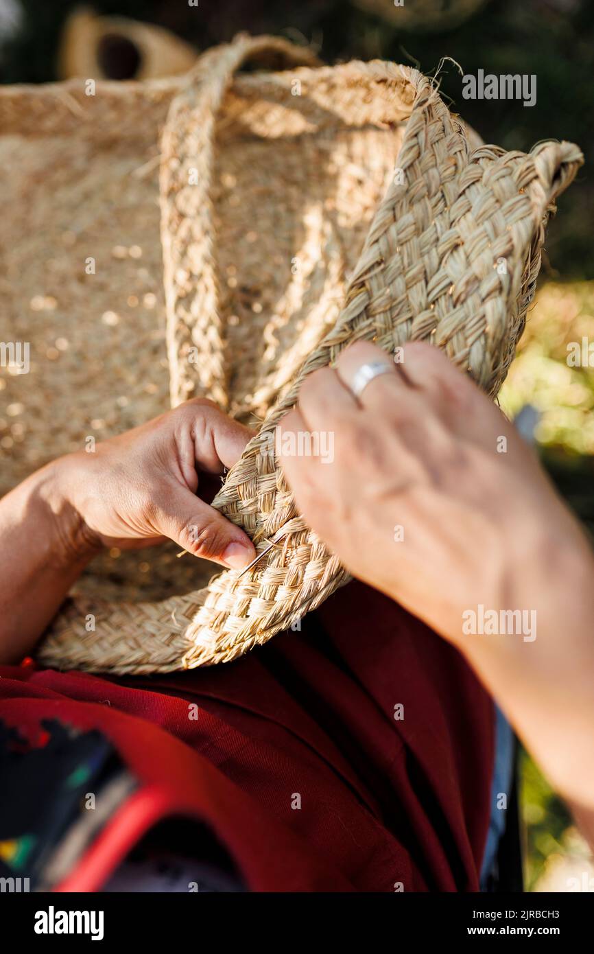 Hands of craftswoman weaving esparto grass basket Stock Photo Alamy