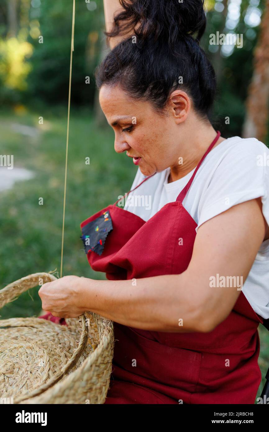 Mature artisan weaving with esparto grass Stock Photo Alamy