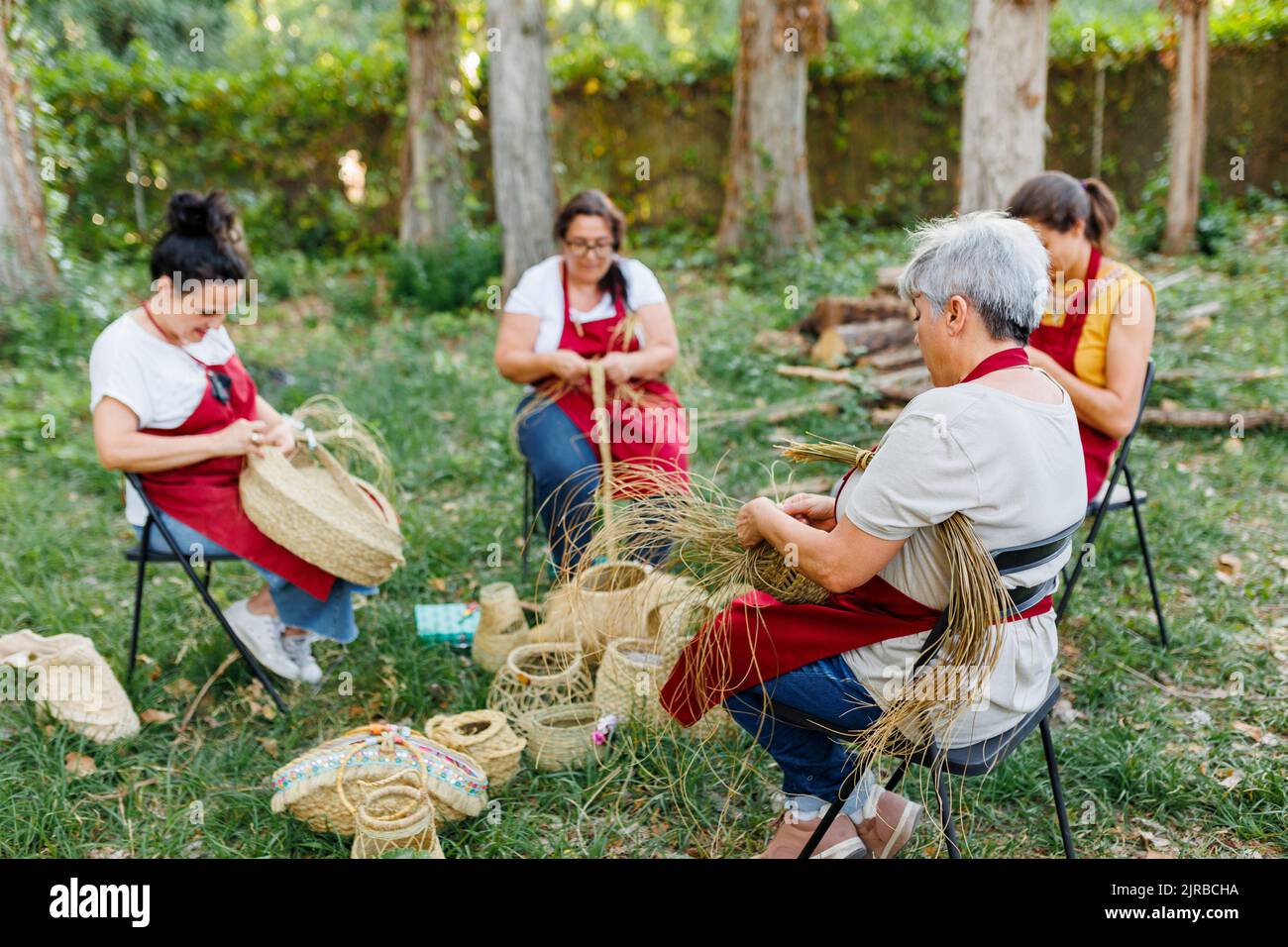 Artisan with coworkers weaving esparto grass in garden Stock Photo Alamy