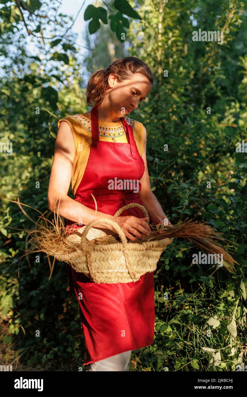 Artisan holding esparto grass basket by plants Stock Photo Alamy