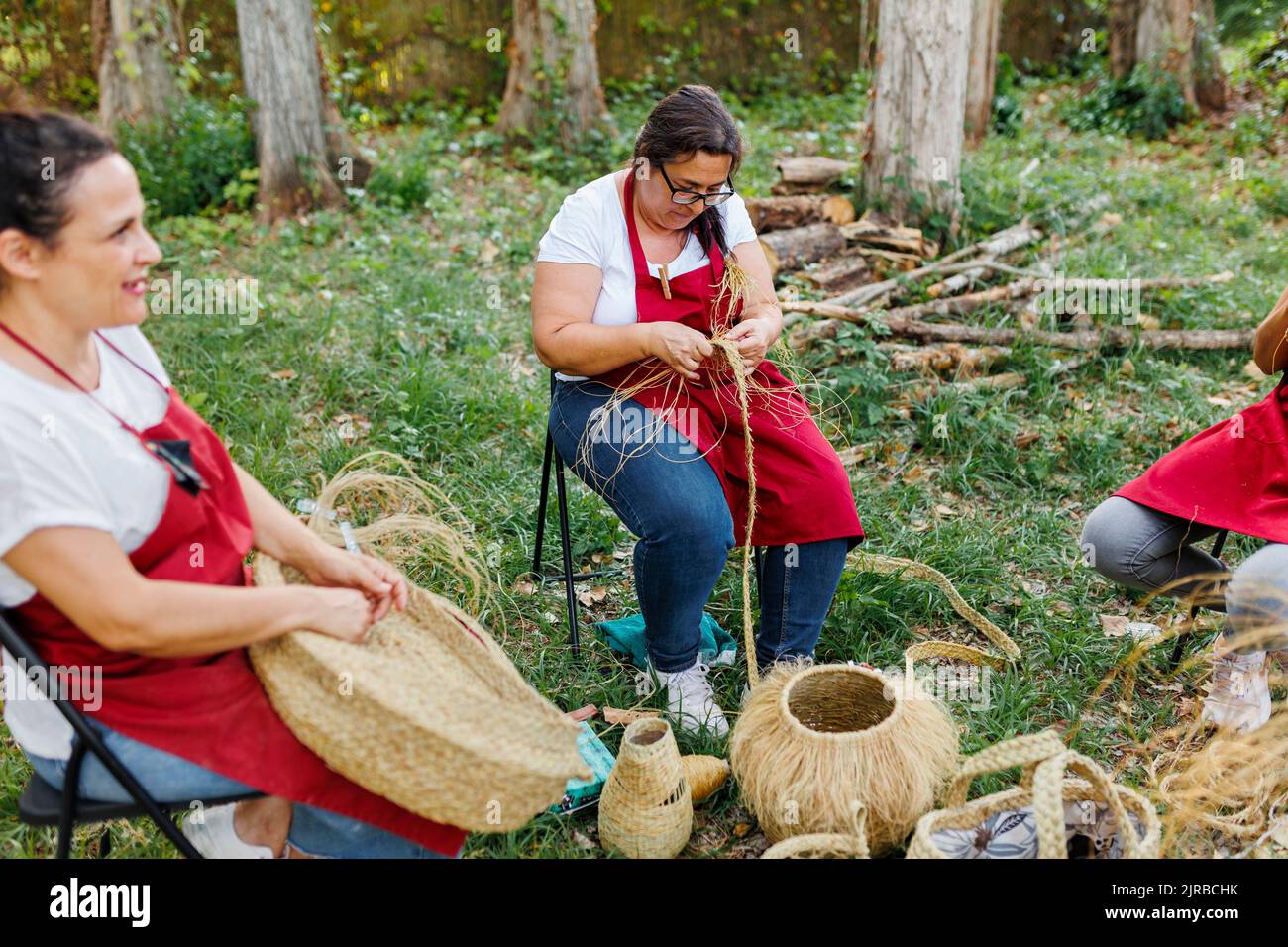 Artisans weaving baskets with esparto grass in garden Stock Photo Alamy