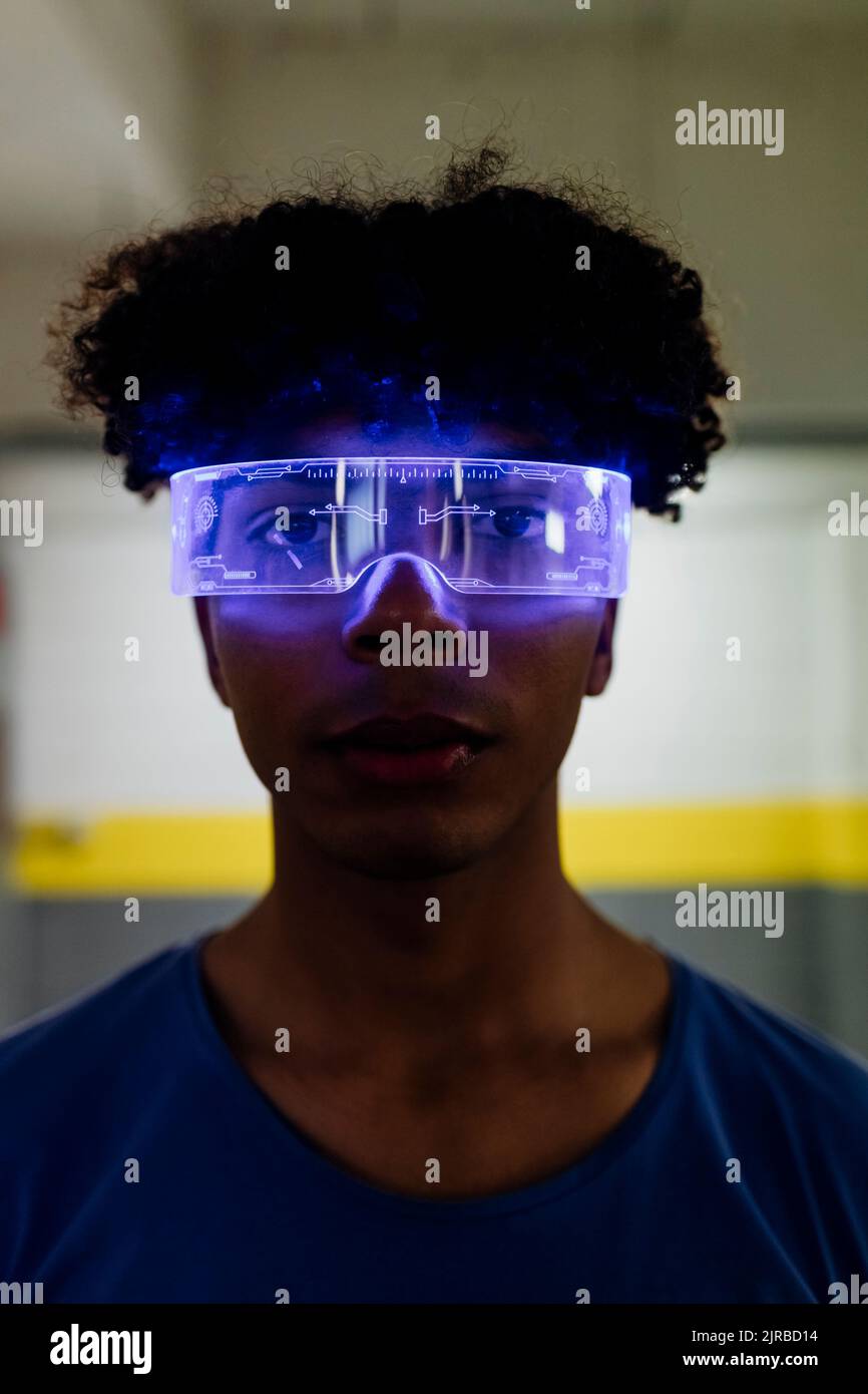 Young man wearing futuristic glasses in subway Stock Photo