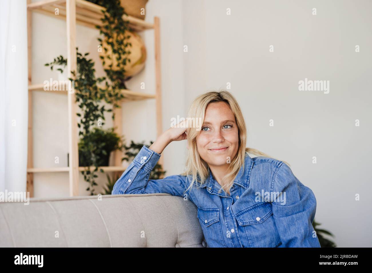 Young women relaxing on sofa hi-res stock photography and images - Alamy