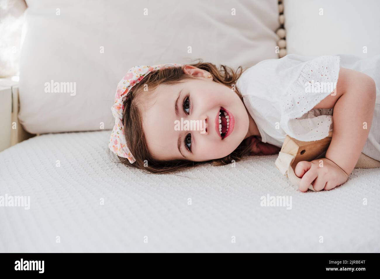 Happy girl lying on sofa hi-res stock photography and images - Alamy