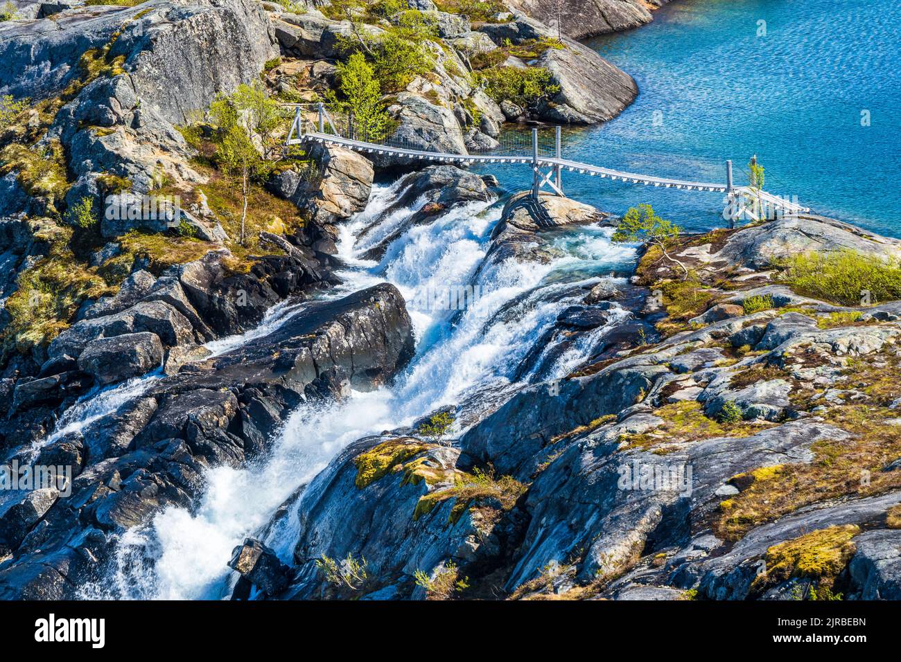 Norway, Nordland, Bridge over Litlverivassfossen waterfall in Rago ...