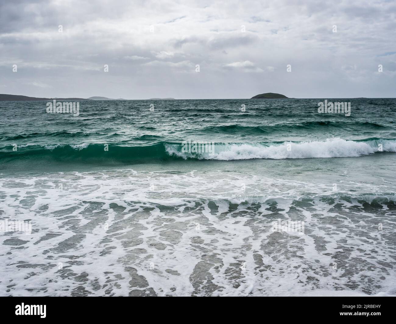 UK, Scotland, Sea waves reaching beach in Outer Hebrides Stock Photo