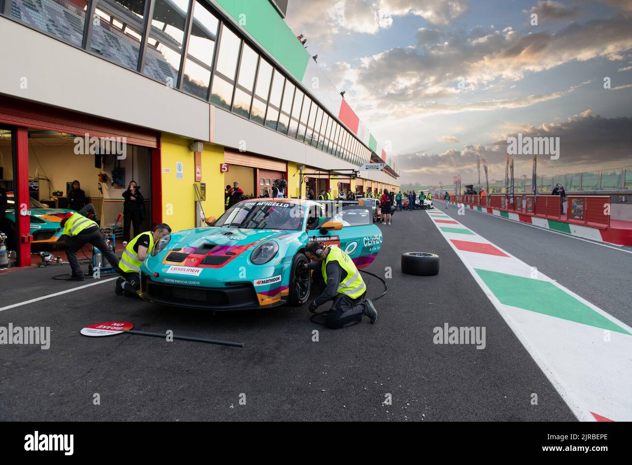 Motor sport scene, Porsche GT race car in circuit pit lane at sunset. Mugello, Italy, march 25 2022. 24 Hours series Stock Photo