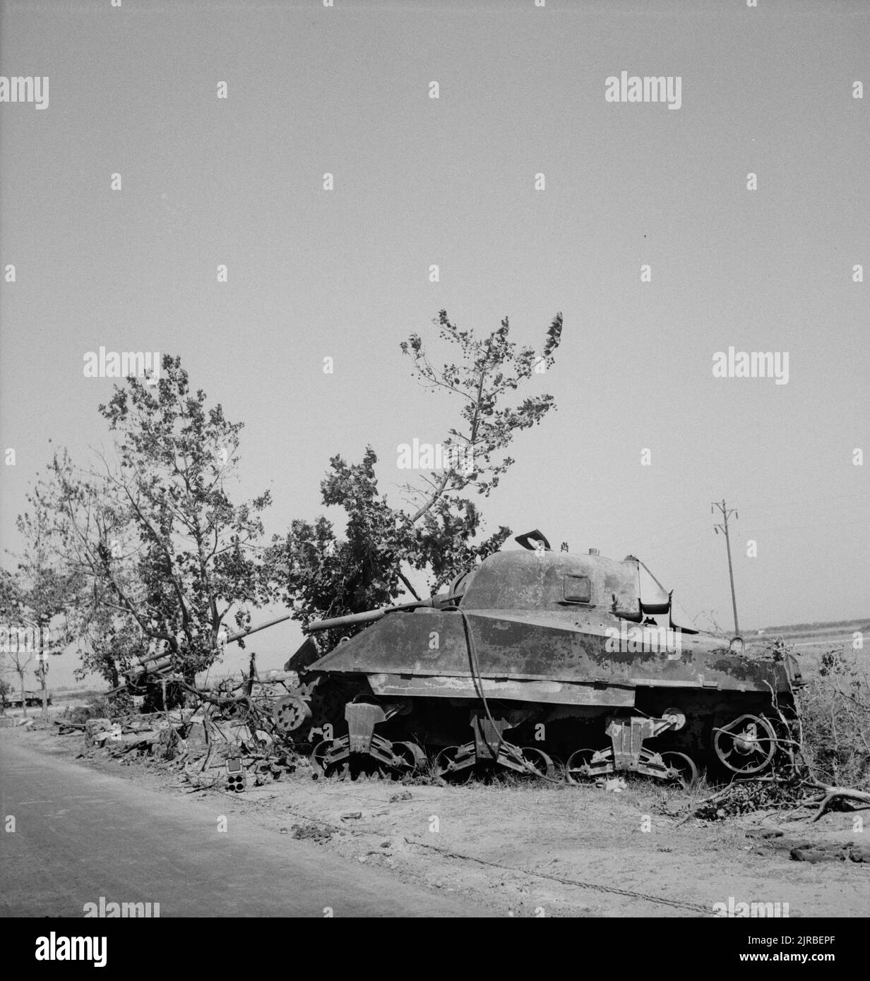 A vintage photo circa September 1943 of a knocked out American M4 Sherman tank next to a destroyed German Flak 88mm  anti-tank artillery gun during the allied invasion of Sicily code named Operation Husky during world war two Stock Photo