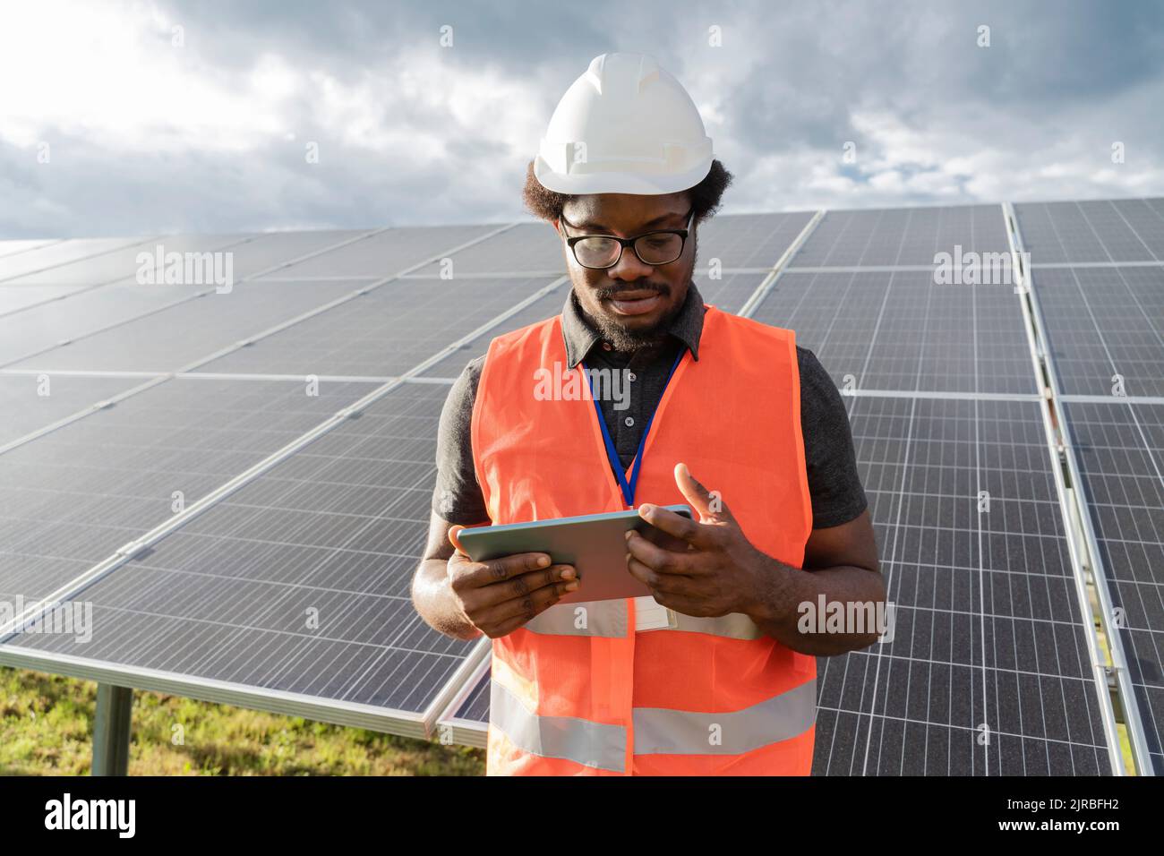 Engineer using tablet PC at solar station Stock Photo