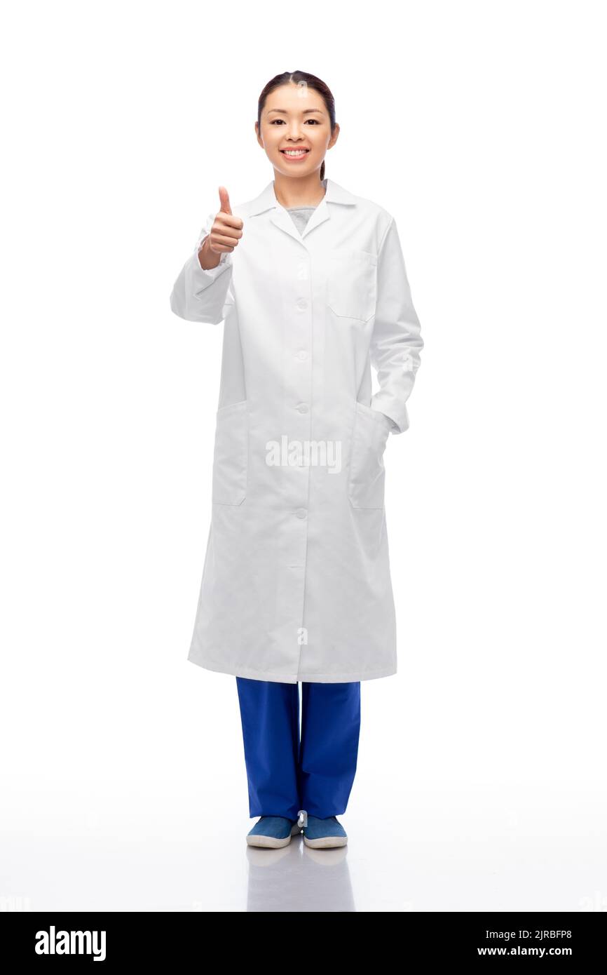 smiling asian female doctor showing thumbs up Stock Photo
